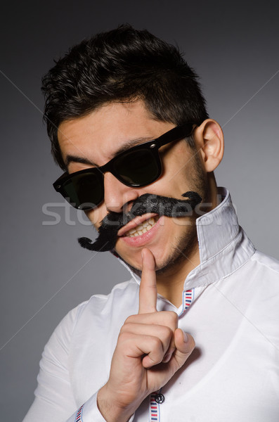 Stock photo: Young caucasian man against gray