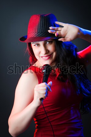 Female performer at disco with mic Stock photo © Elnur