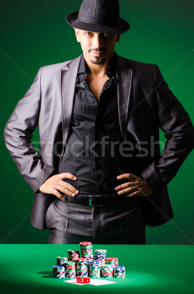 Stock photo: Man playing in dark casino