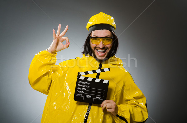 Man wearing yellow suit with movie board Stock photo © Elnur