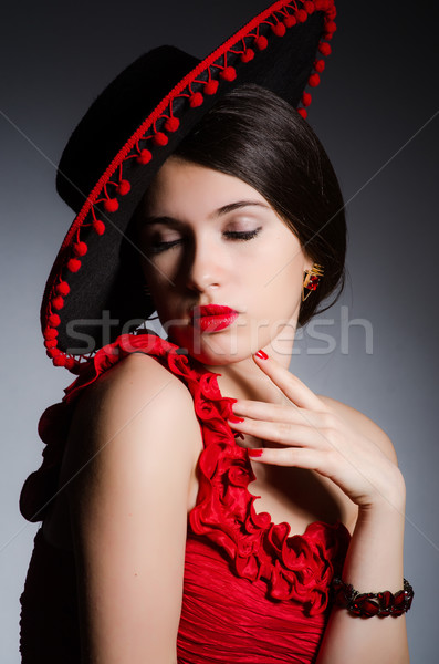 Woman wearing hat against dark background Stock photo © Elnur