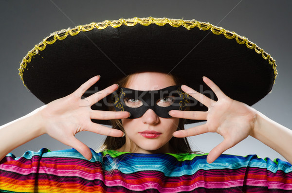 Girl in mexican vivid poncho against gray Stock photo © Elnur
