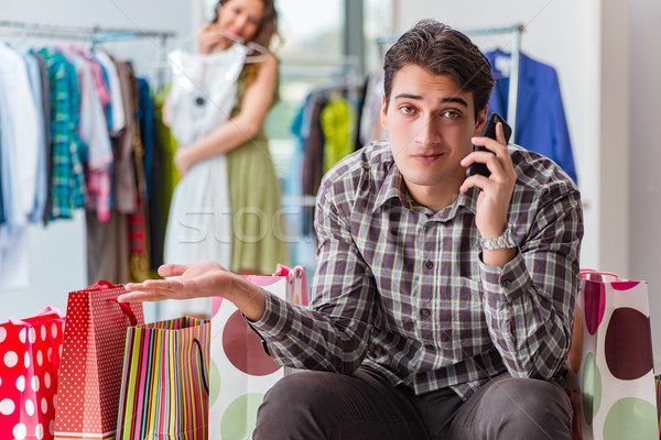 The man fed up with wife shopping in shop Stock photo © Elnur