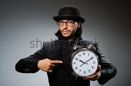 Stock photo: Man prisoner with clock isolated on white