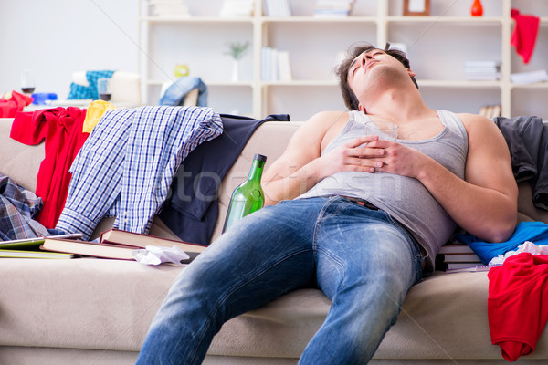 Young man student drunk drinking alcohol in a messy room Stock photo © Elnur