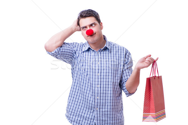 Man with a red nose funny holding a shopping bag gift present is Stock photo © Elnur