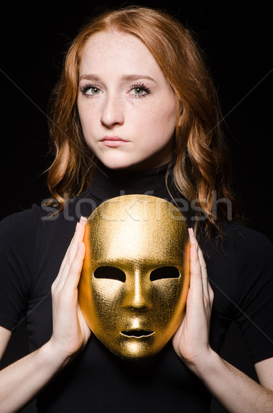 Redhead woman iwith mask in hypocrisy consept against black  bac Stock photo © Elnur