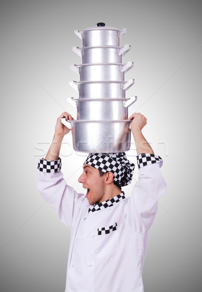 Cook with stack of pots on white Stock photo © Elnur