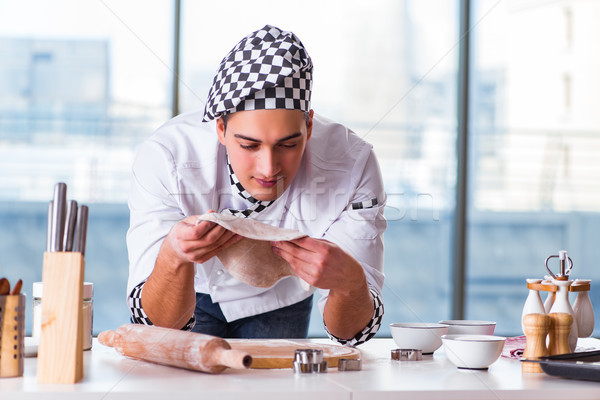 Young man cooking cookies in kitchen Stock photo © Elnur