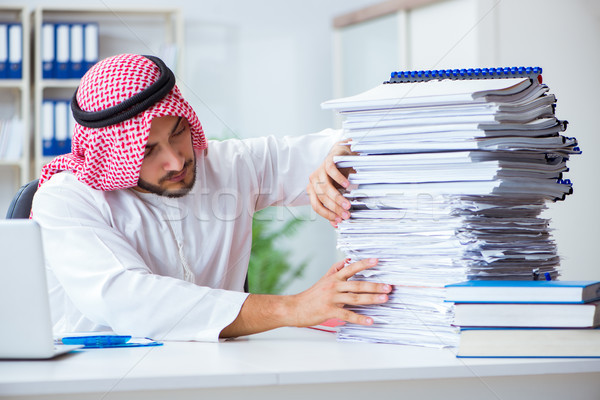 Arab businessman working in the office doing paperwork with a pi Stock photo © Elnur