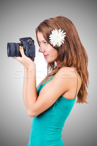 Stock photo: Attractive female photographer on white
