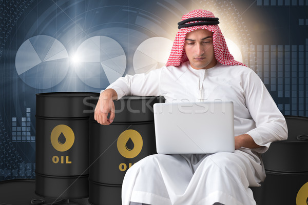 Arab businessman trading crude oil on laptop Stock photo © Elnur