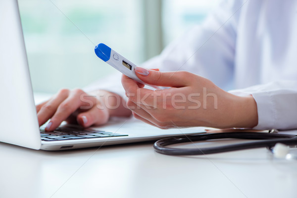 Doctor hand holding temperature thermometer Stock photo © Elnur