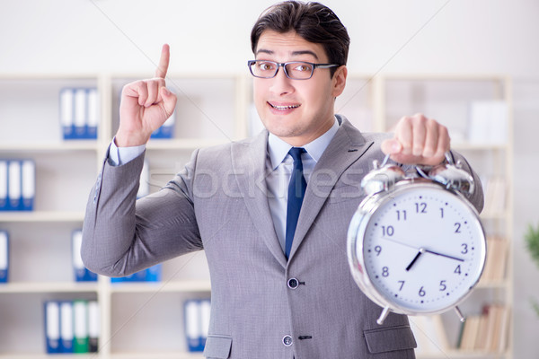Businessman with alarm clock in the office Stock photo © Elnur