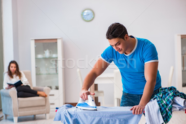 Man husband ironing at home helping his wife Stock photo © Elnur