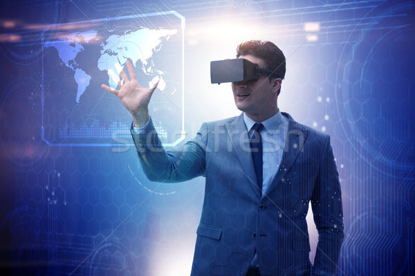 Businessman in virtual reality trading on stock market Stock photo © Elnur