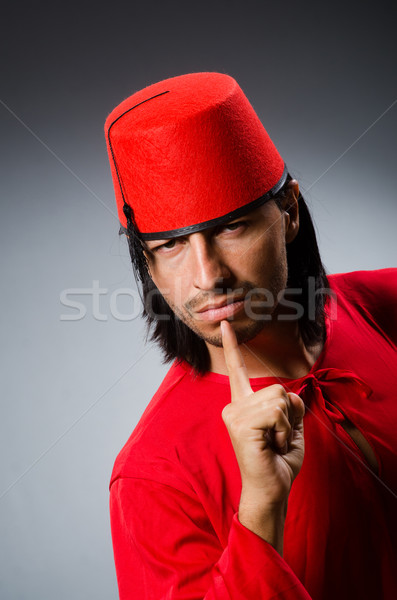 Man in red dress wearing fez hat Stock photo © Elnur