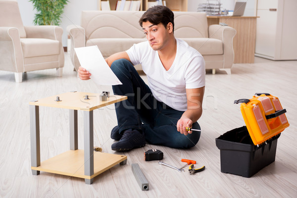 Man assembling shelf at home Stock photo © Elnur