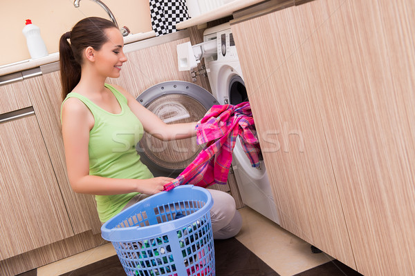 Young wife woman washing clothes near machine Stock photo © Elnur