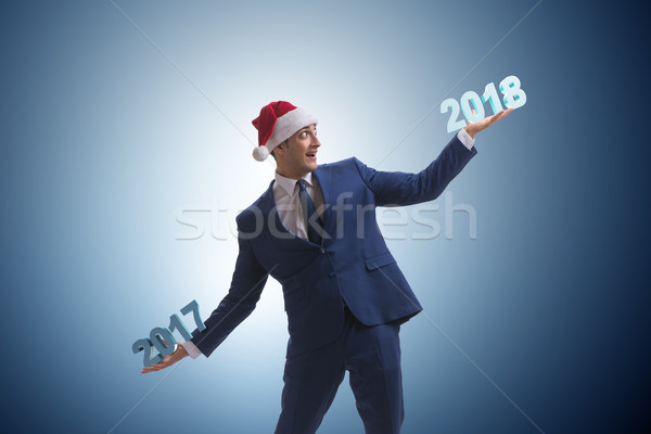 Businessman in santa hat holding 2017 and 2018 Stock photo © Elnur