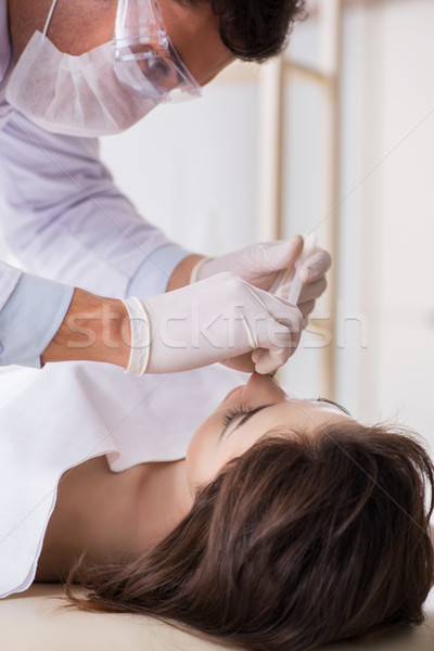 Police coroner examining dead body corpse in morgue Stock photo © Elnur