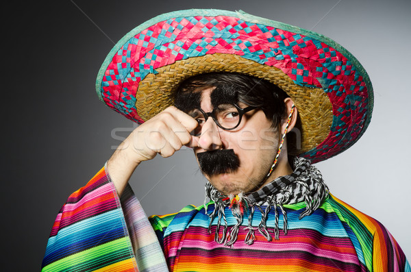 Man in vivid mexican poncho against gray Stock photo © Elnur