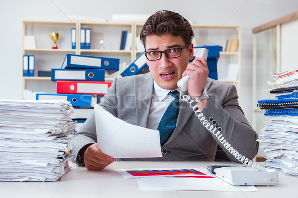 Businessman busy with much paperwork Stock photo © Elnur