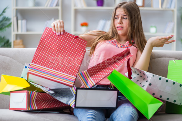 Young woman with shopping bags indoors home on sofa Stock photo © Elnur