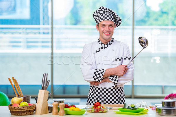 Stock photo: Male cook preparing food in the kitchen