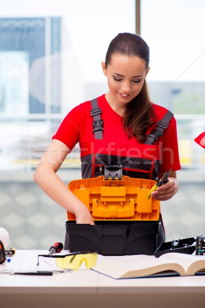 The young woman in coveralls doing repairs Stock photo © Elnur