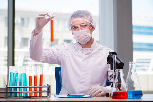 Man working in the chemical lab on science project Stock photo © Elnur