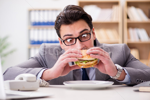 The hungry funny businessman eating junk food sandwich Stock photo © Elnur