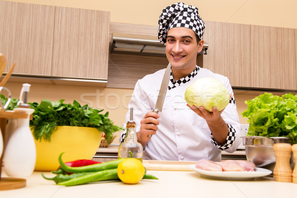 Stock photo: Young chef working in the kitchen