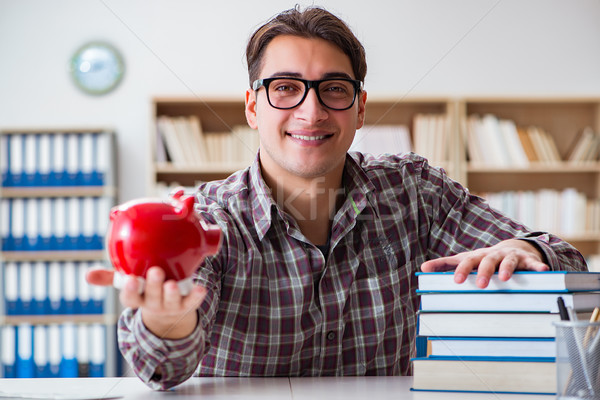 Student breaking piggybank to pay for tuition fees Stock photo © Elnur