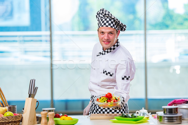 Male cook preparing food in the kitchen Stock photo © Elnur