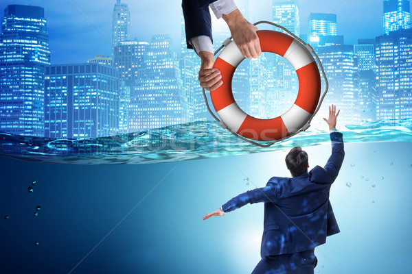 Businessman being saved from drowning Stock photo © Elnur