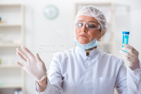 Woman chemist pressing virtual button in lab Stock photo © Elnur