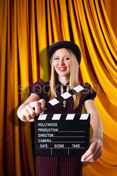 Stock photo: Woman gangster with movie clapper