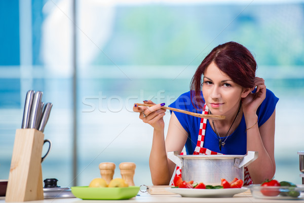 Woman preparing soup in the kitchen Stock photo © Elnur