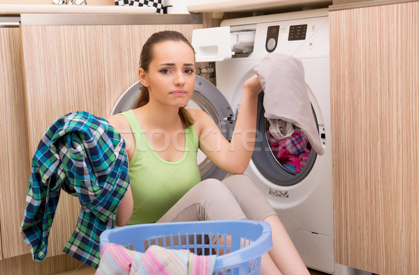 Stock photo: Woman doing laundry at home