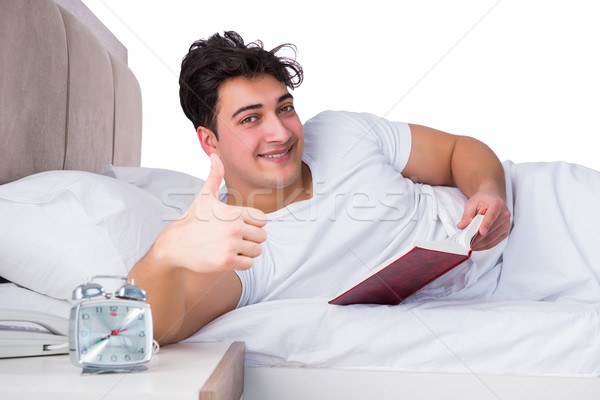 Férfi ágy szenvedés álmatlanság könyv óra Stock fotó © Elnur