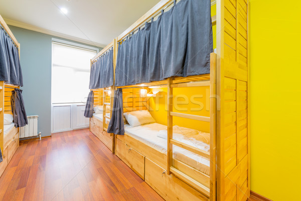 Hostel dormitory beds arranged in room Stock photo © Elnur