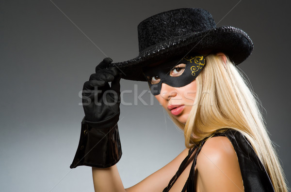 Woman wearing mask against dark background Stock photo © Elnur