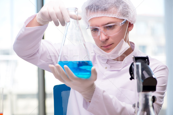 Man working in the chemical lab on science project Stock photo © Elnur