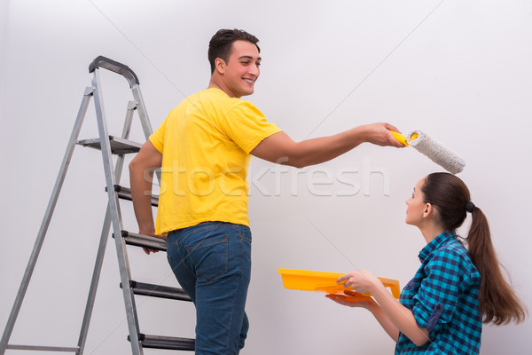 Young couple painting wall at home Stock photo © Elnur