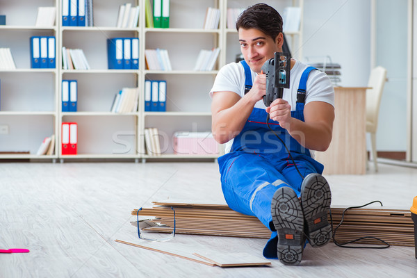 The young worker working on floor laminate tiles Stock photo © Elnur