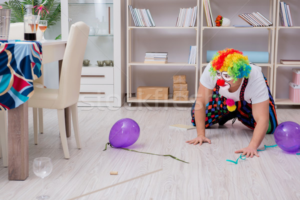 Stock photo: The drunk clown celebrating having a party at home