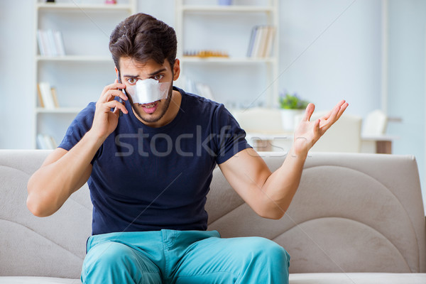Young man recovering healing at home after plastic surgery nose  Stock photo © Elnur