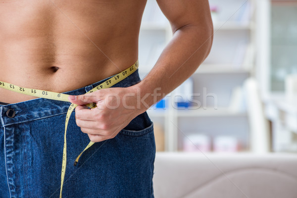 Férfi túlméretezett nadrág fogyókúra egészség testmozgás Stock fotó © Elnur