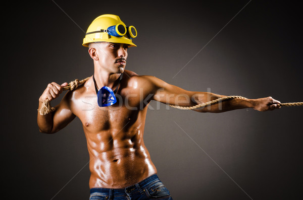 Nude builder pulling rope in darkness Stock photo © Elnur